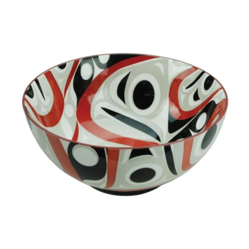 Decorative bowl with red, black, and white abstract pattern on a white background