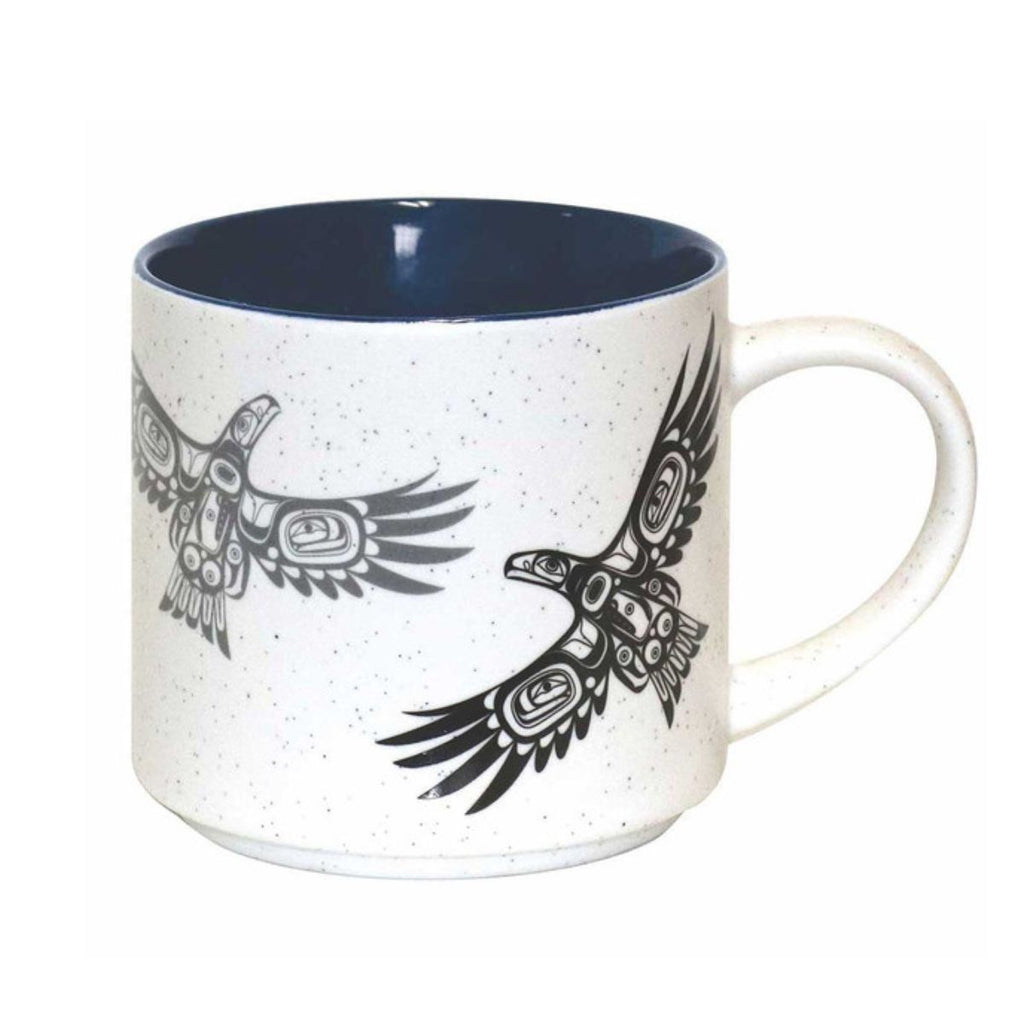 White mug with black eagle designs on a white background