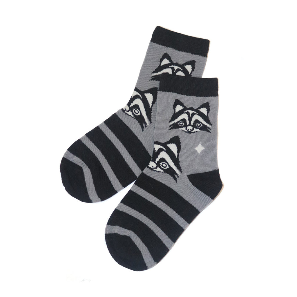 Two socks with raccoon designs on a white background