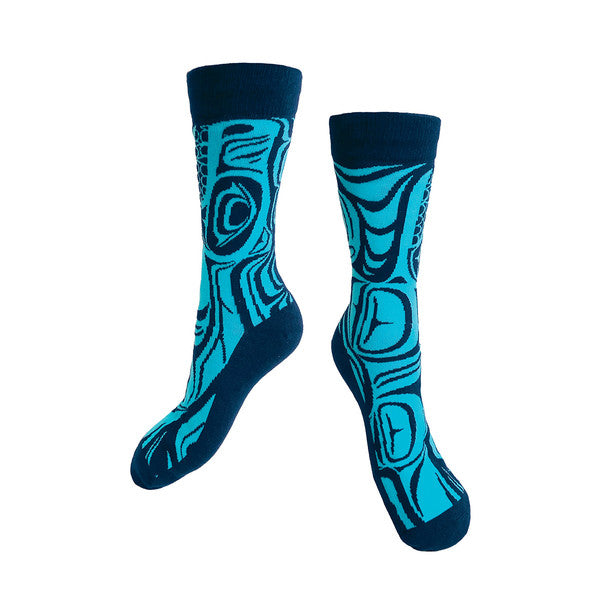 Pair of blue and black socks with abstract pattern on a white background