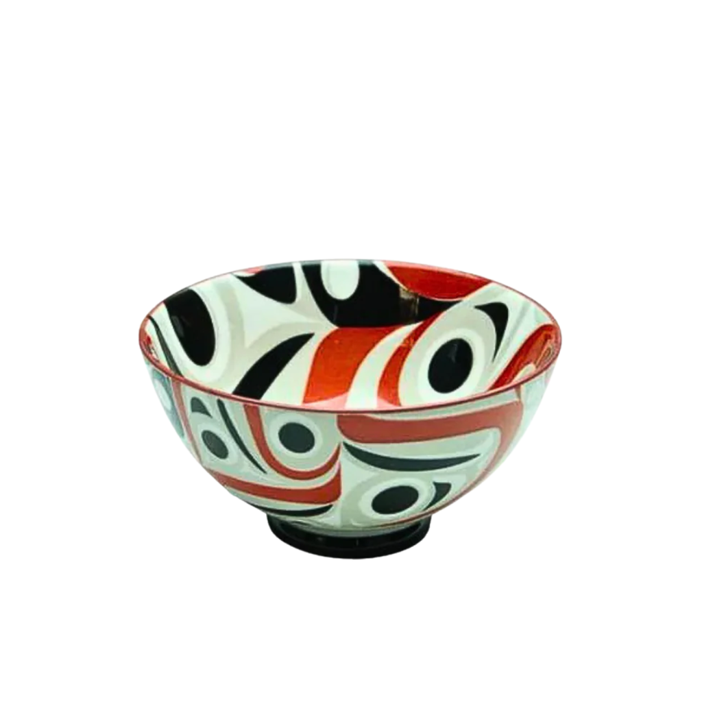 Decorative ceramic bowl with black, red, and white abstract pattern on a white background