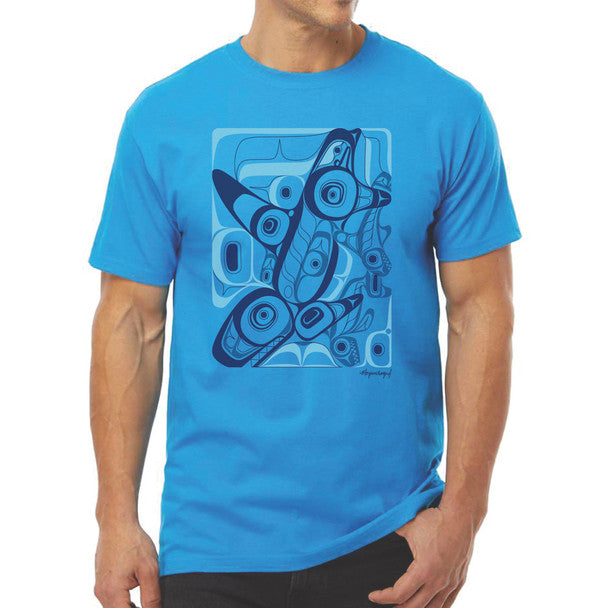 Person wearing a blue t-shirt with a graphic native orca design on a white background